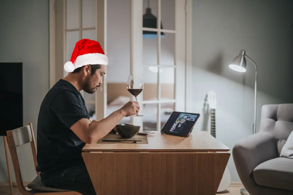 Man with santa hat on a virtual date.