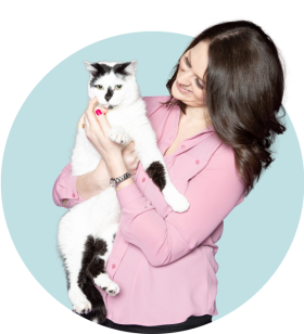 woman smiling and holding her cat