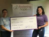 Fostering Hope receives their check from Embrace of $6,500