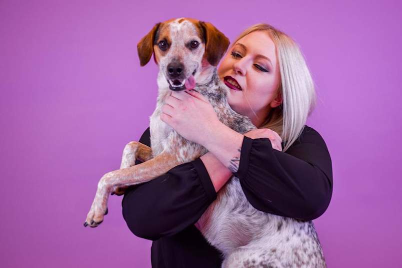 dog being held by it's owner while learning not to bark