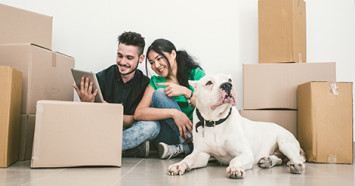 couple-and-dog-surrounded-by-moving-boxes