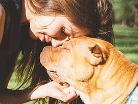 Woman touching heads with dog