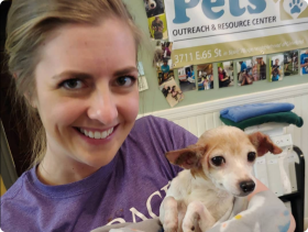 Embrace Pet Insurance female employee holding chihuahua dog 