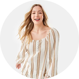 a woman wearing a beige striped long sleeve bl