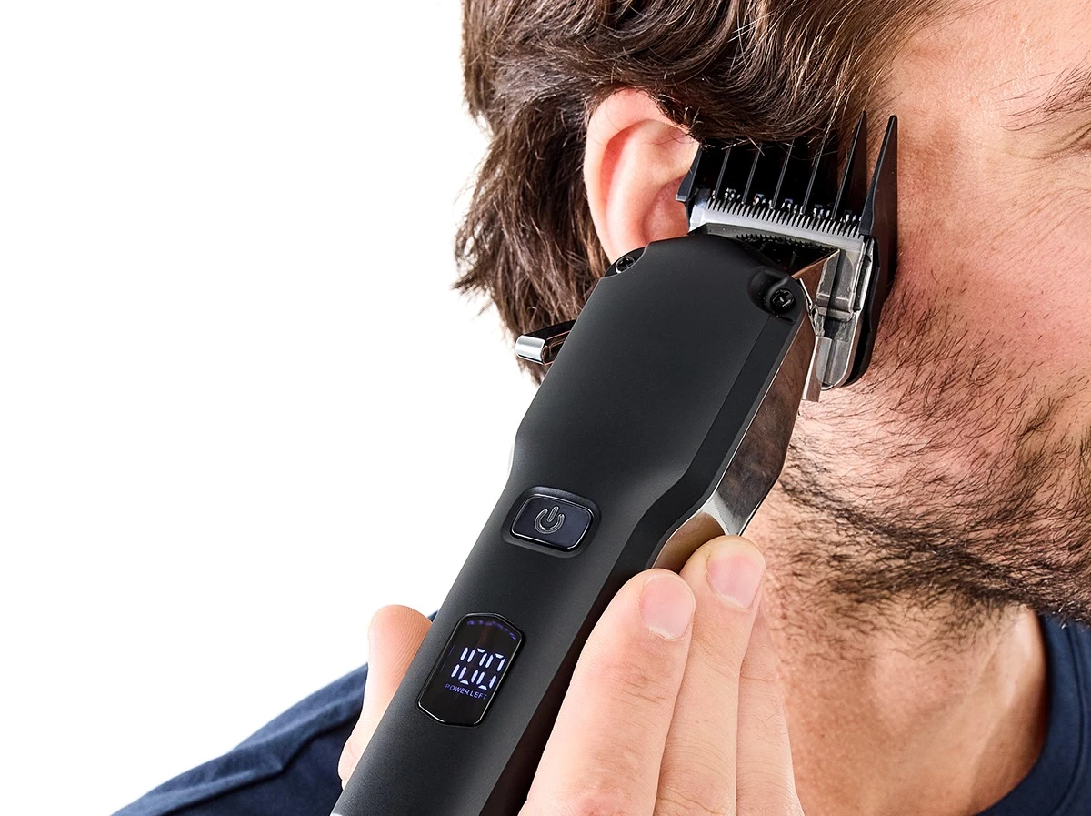 Man Grooming Hair Using Professional Hair Cut