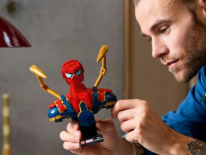 Adult male building Lego Spiderman 