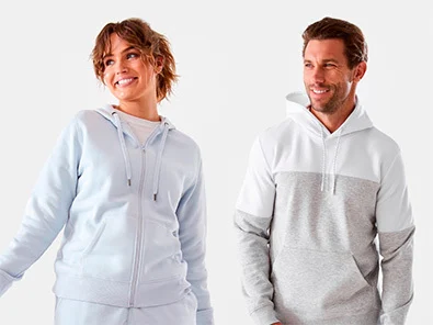 woman wearing the active womens core zip through hoodie and a man wearing the active colour block fleece hoodie