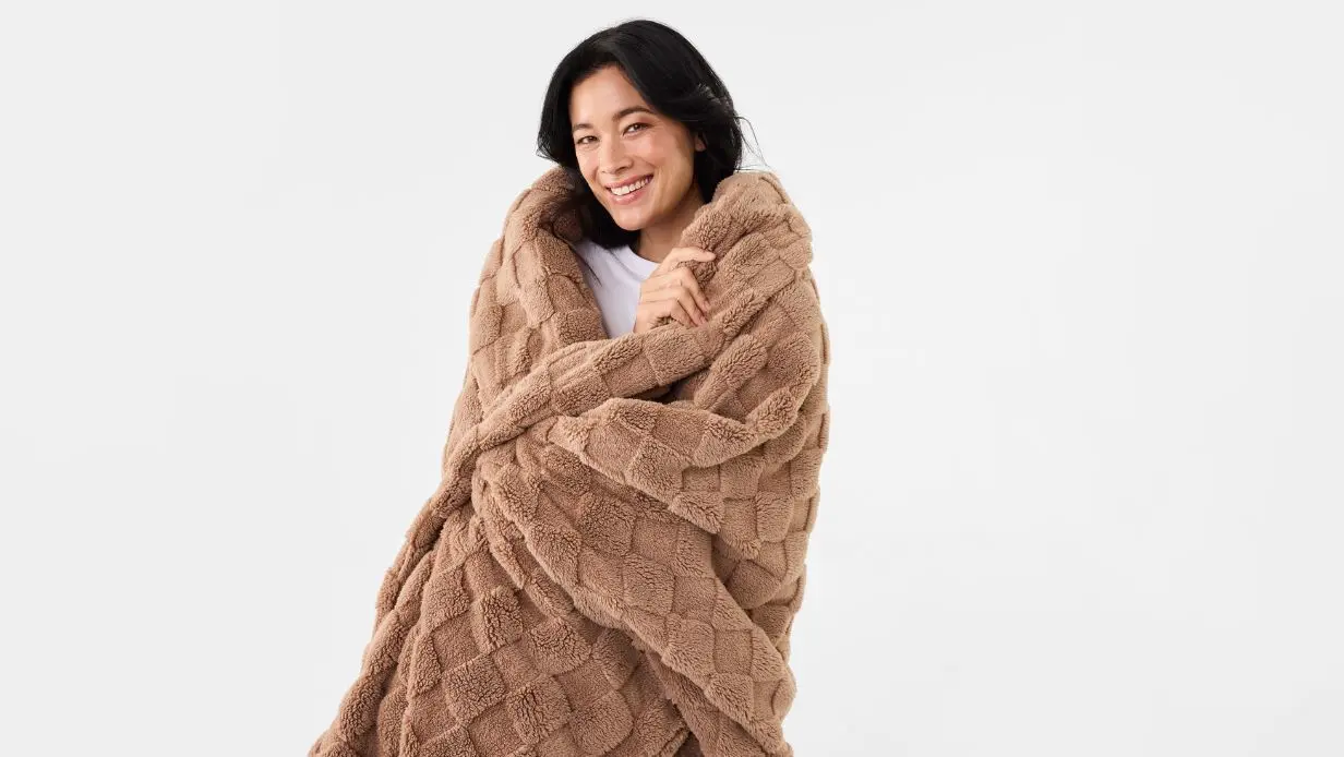 woman wrapped in cosy blanket