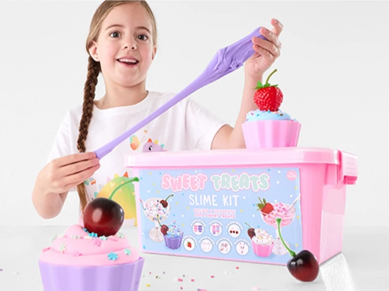 Young girl playing with sweet treats slime kit