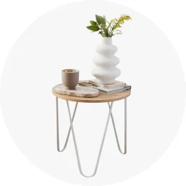 living room side table holding a white 