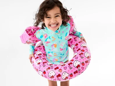 Little girl wearing swimwear with a floatie