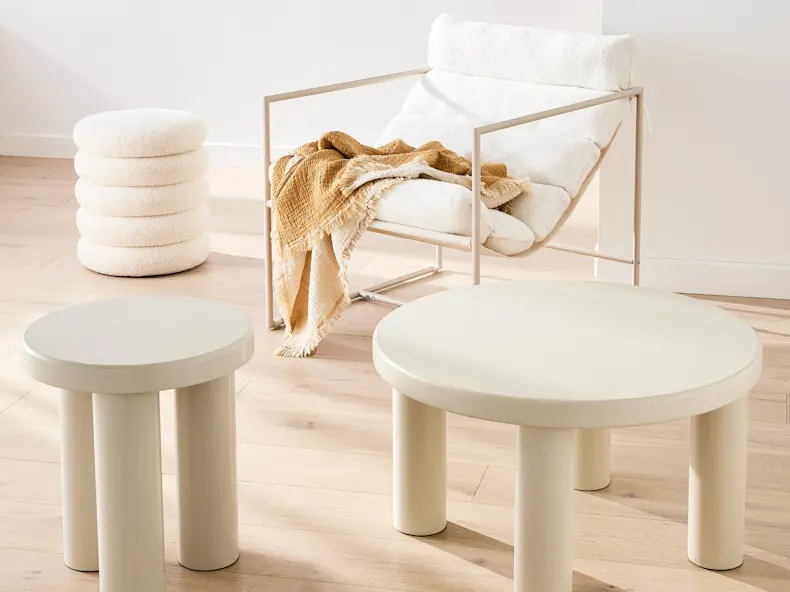 White furniture including a 3 legged chair, coffee table boucle ottoman and marlow lounge chair