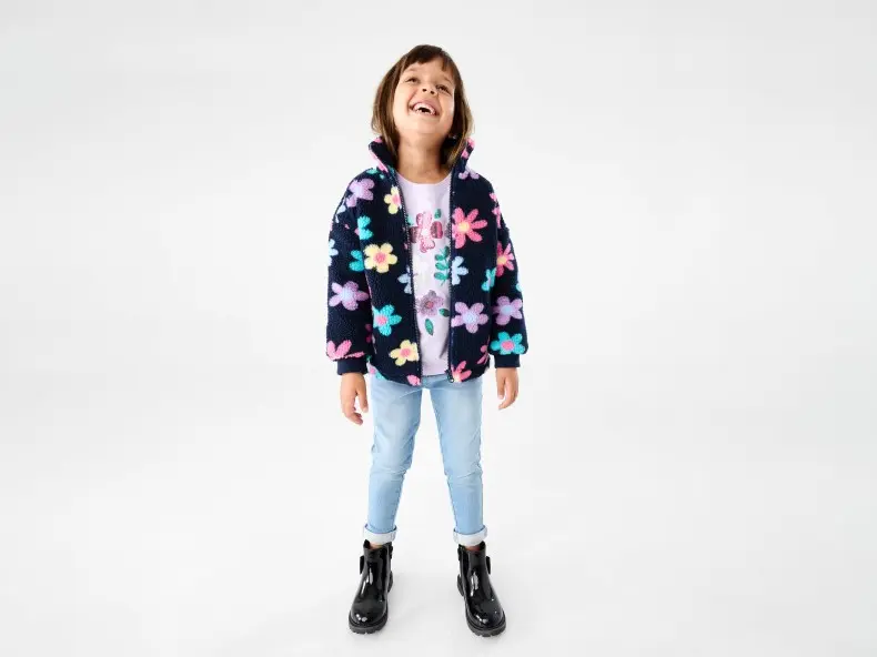 girl wearing teddy jacket with flowers