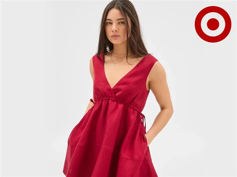 a woman wearing sleeveless v neck dress