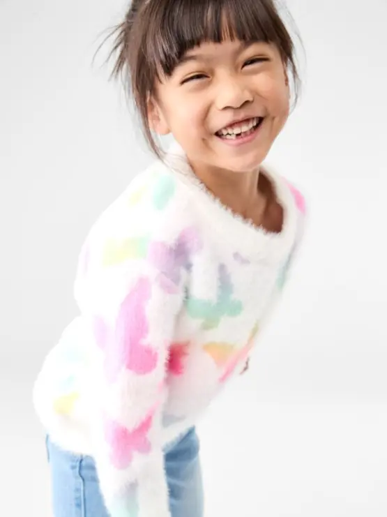 girl wearing the rainbow butterfly knit ju
