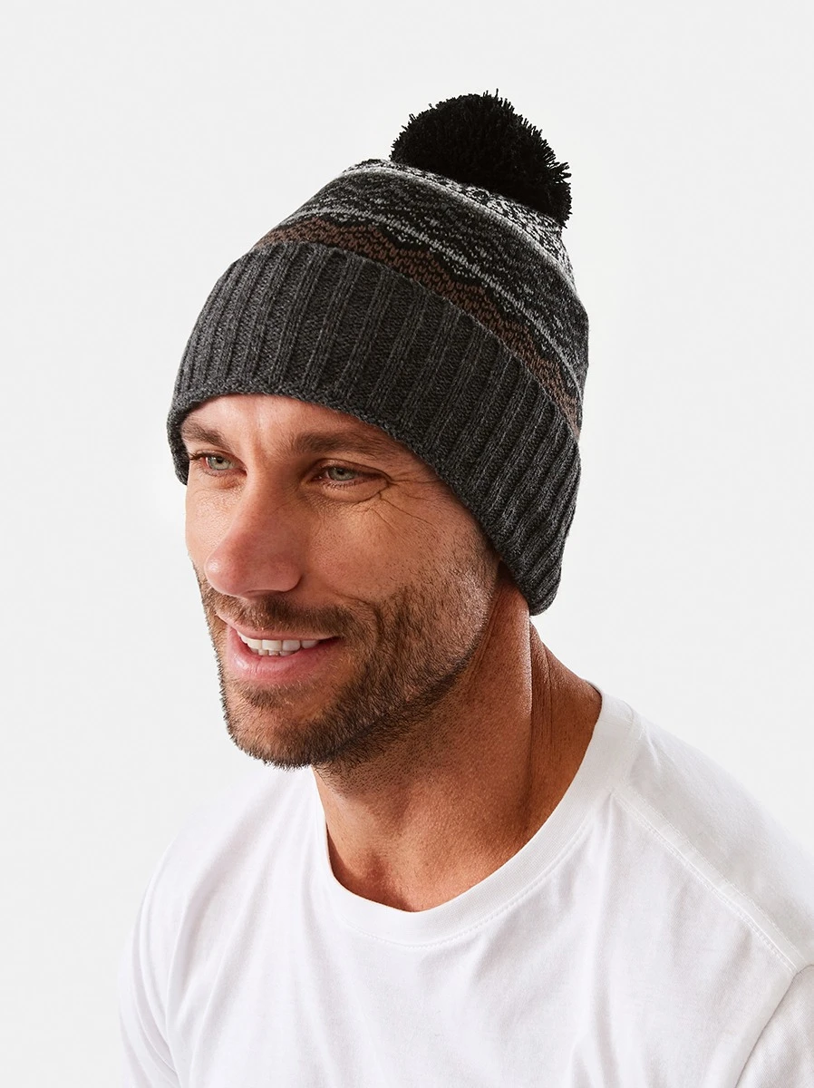 Man wearing a chunky pom pom beanie