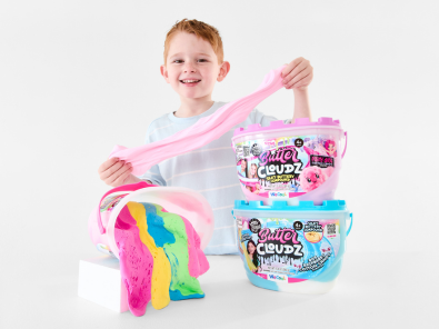 Young boy playing with colourful slime