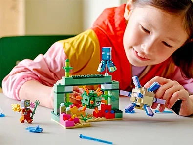 girl playing with lego set