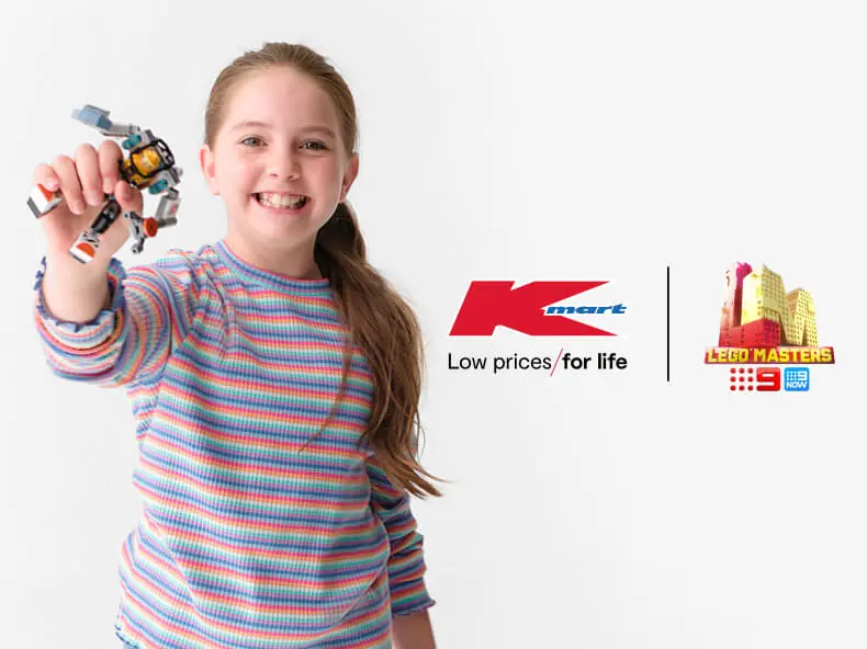 girl holding Lego playset