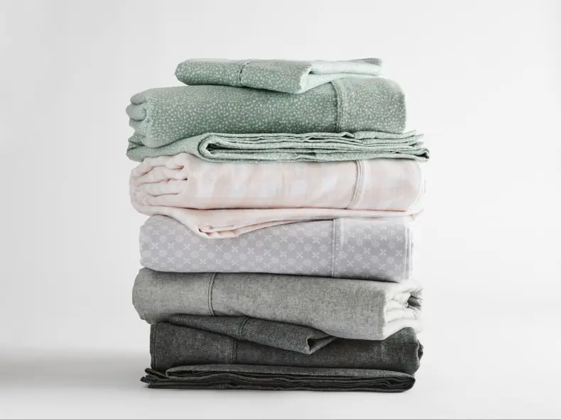 stack of flannelette sheets in different colours and prints