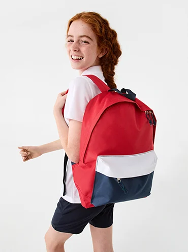 girl holding a red and blue back