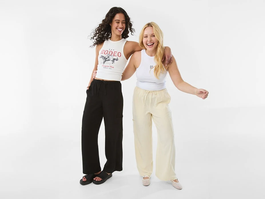 Women wearing new styles in apparel like embroidered tank top and cargo pants