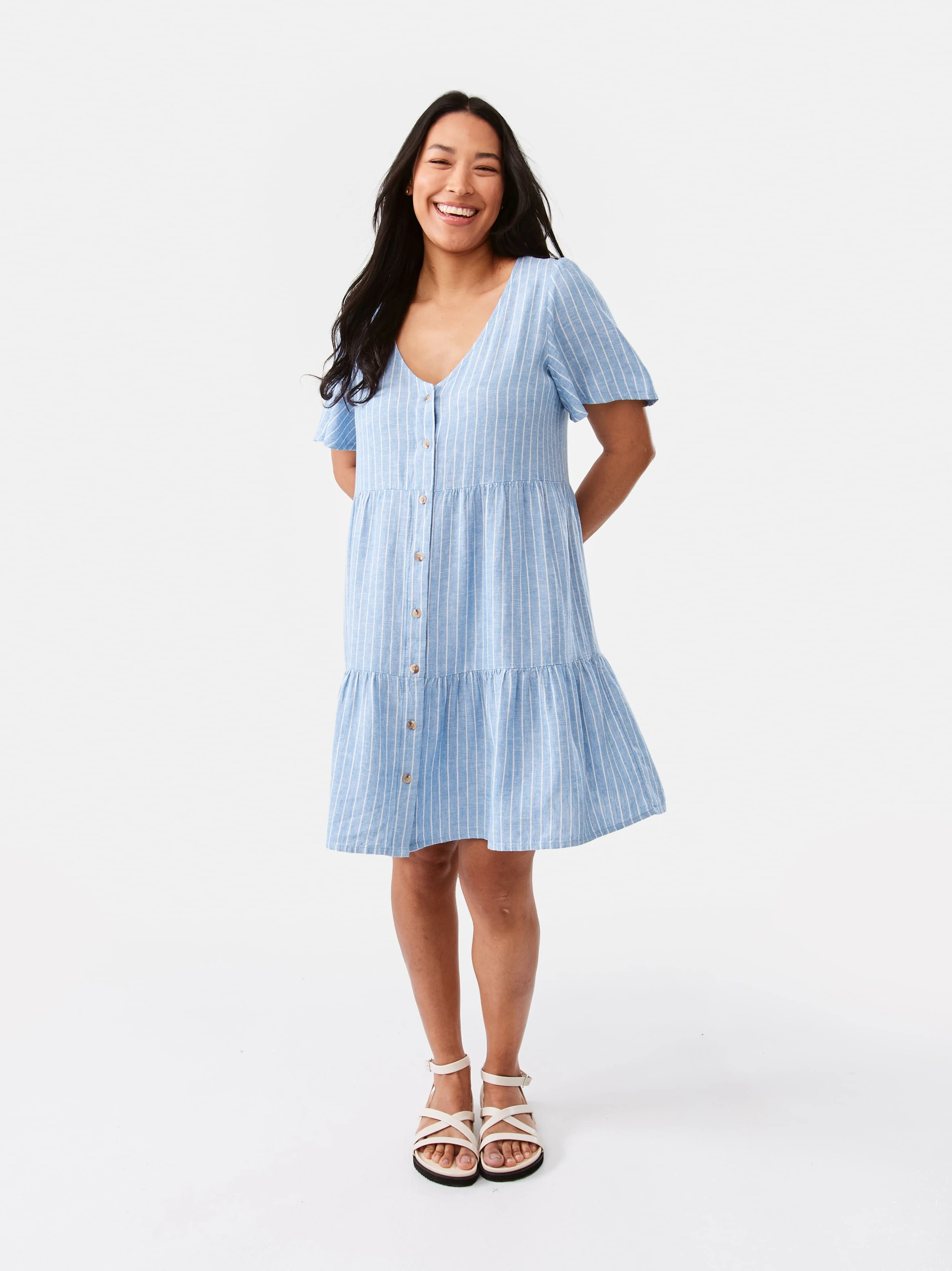 Talent wearing Linen Blend Short Sleeve Tiered Mini Dress in blue stripes pat