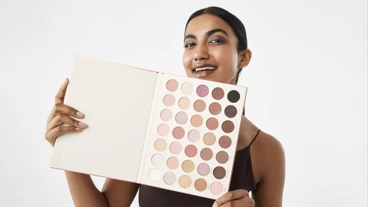 woman holding the OXX Cosmetics 35 Shades Sparkling Rose Eyeshadow Palette