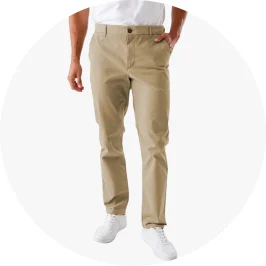 a man in tanned chino pants and white snea