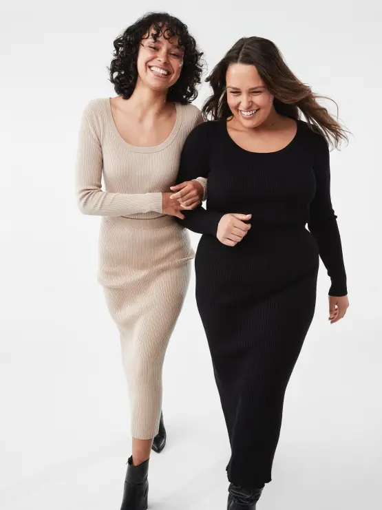 two woman wearing balck and cream top and skirt