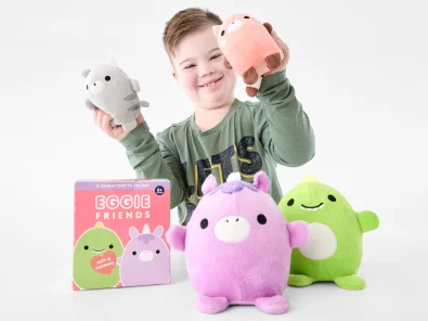 young boy playing with the Eggie Friends Soft and Squeezy Plush