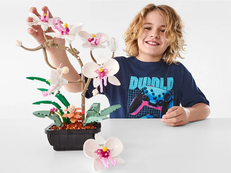 Kid Playing With 584 Piece Mini Blocks Flower Series: Orchid Playset