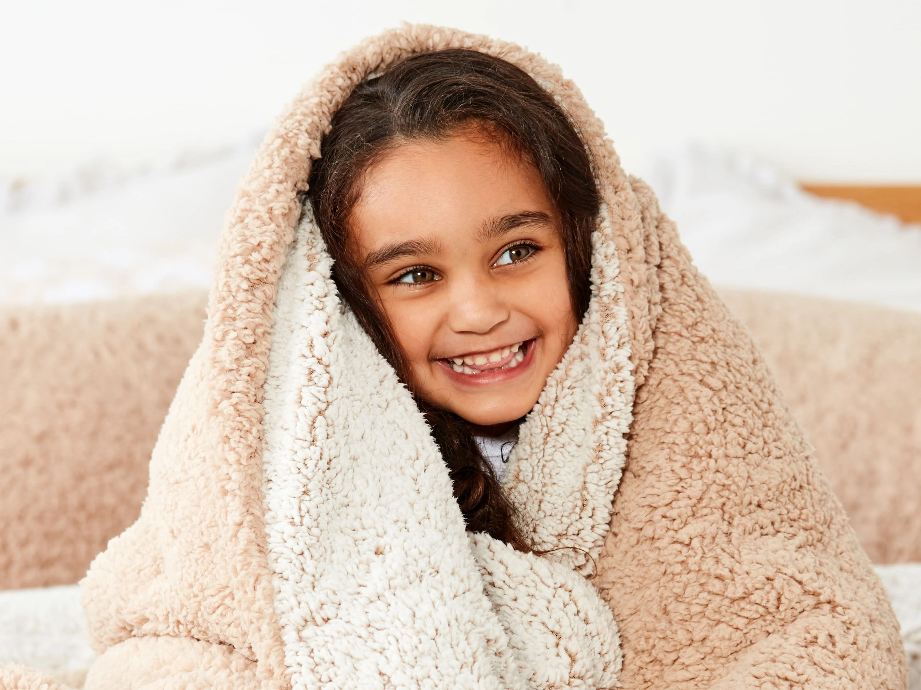 little girl wrapped in a warm blanket