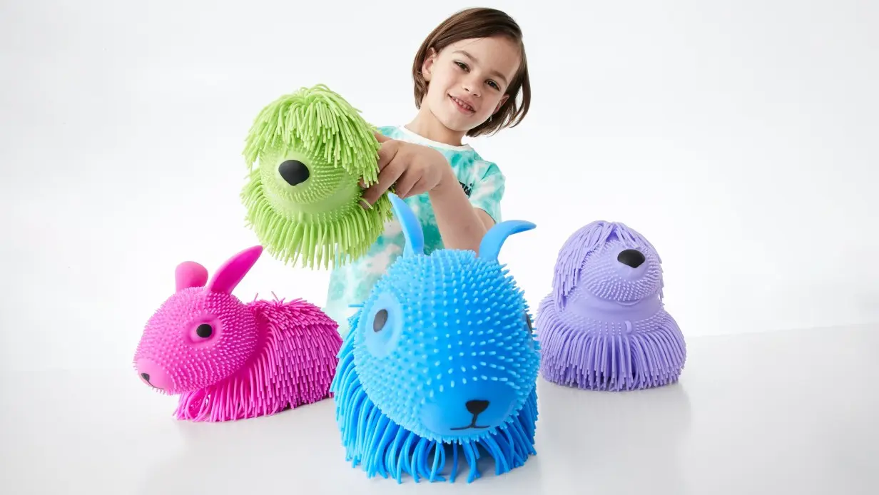 young girl playing with squishable toys