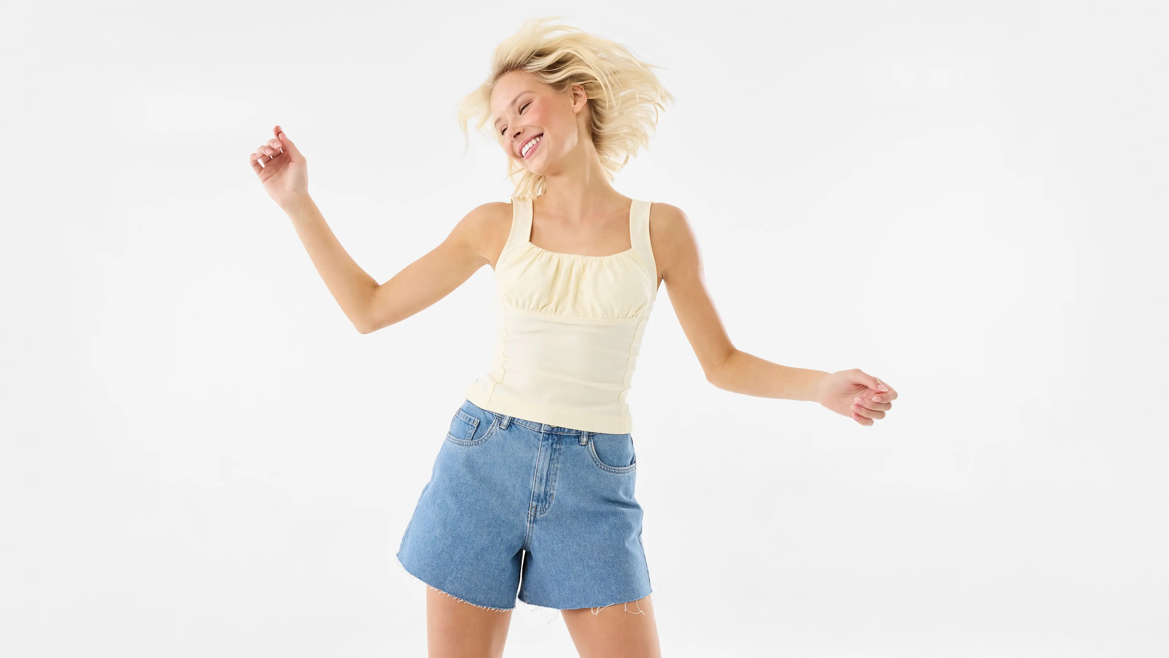 Yellow top paired with denim shorts