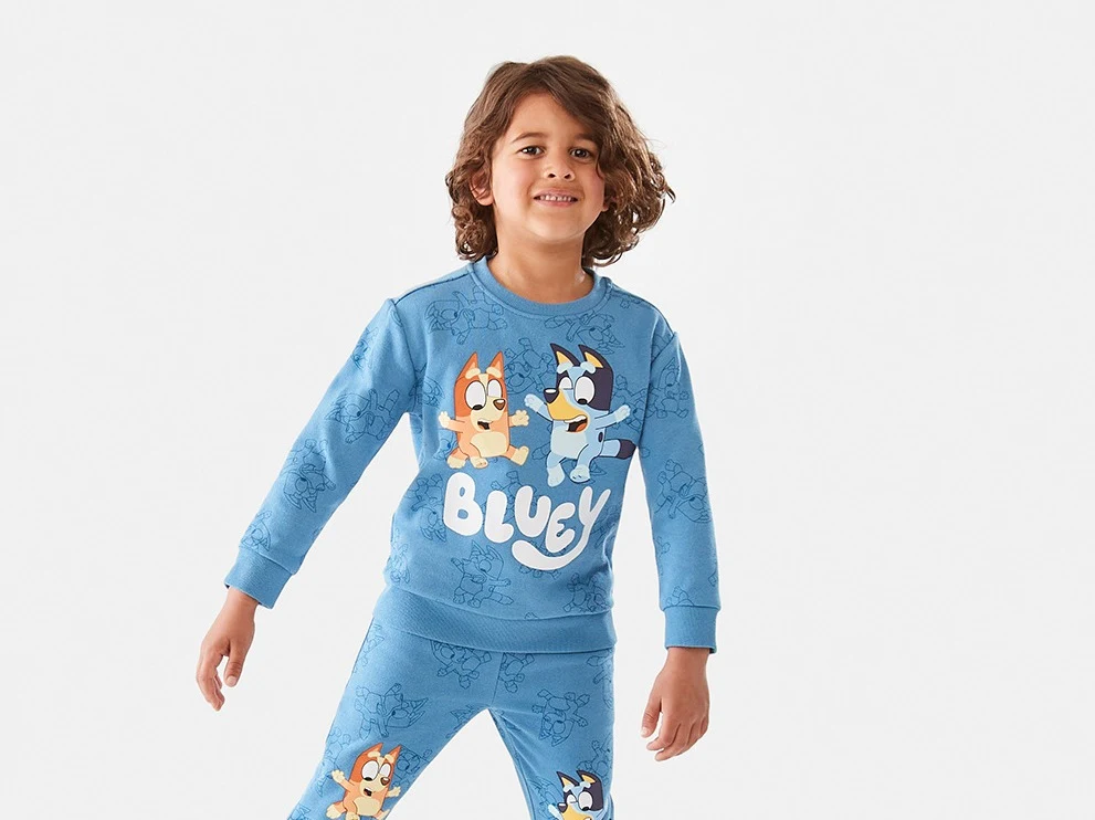 a boy wearing a Bluey License Print Crew Neck Sweats
