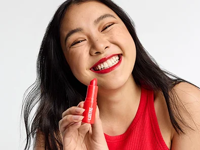 girl smiling holding a creulty free lipstick