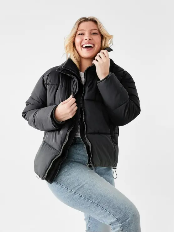 woman wearing a black puffer jacket and blue j
