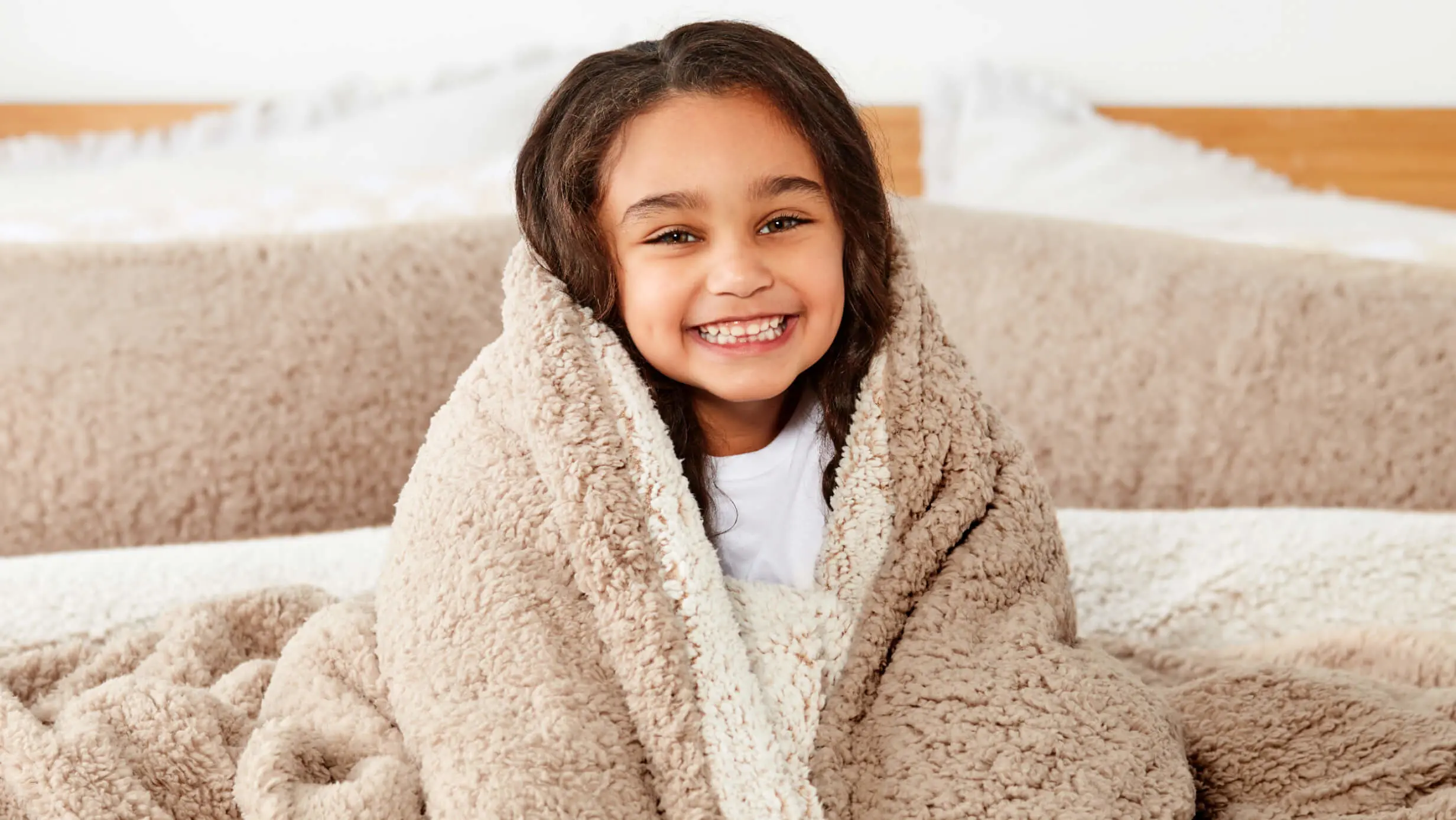 young girl wrapped up in a blanket