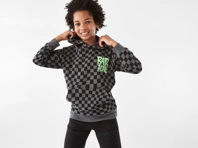 young boy wearing a checkered hoodie