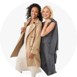 one woman with a light tan trench coat and dress, with second woman in a matching pin stripe blazer