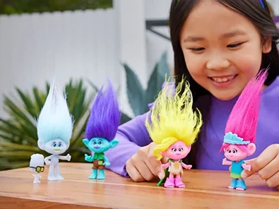 girl playing with troll toys