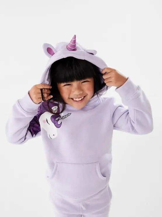 girl wearing purple novelty unicorn ho