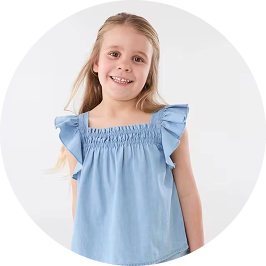 a girl wearing blue chambray top with wing sle