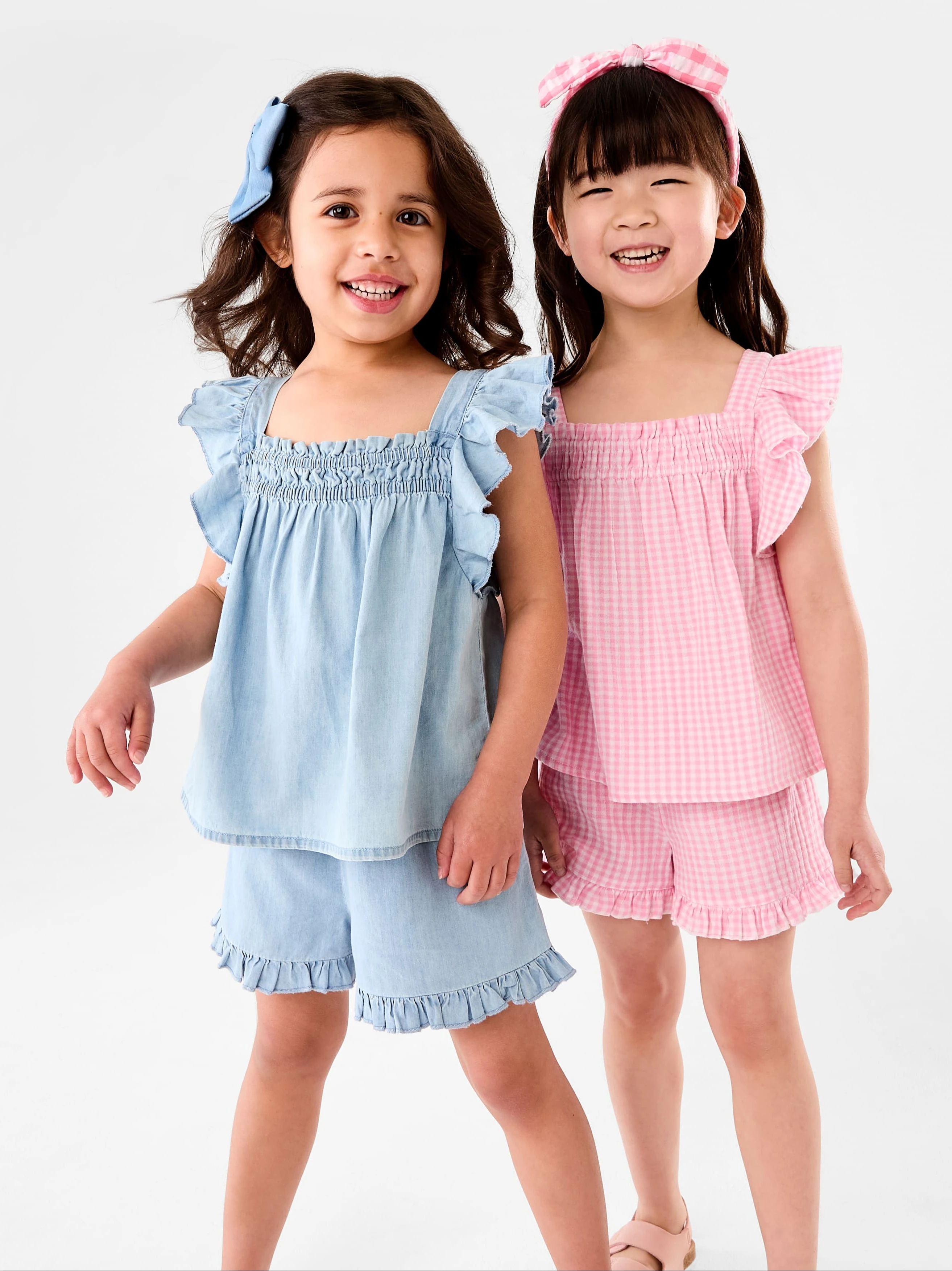 2 girls wearing butterfly sleeves matching top and sh