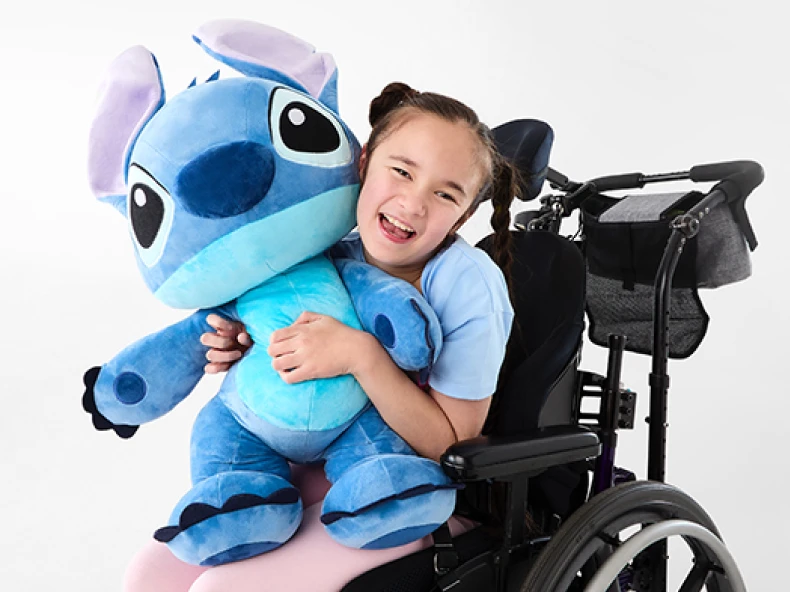 Girl holding lovingly Disney Giant Stitch Plush Toy