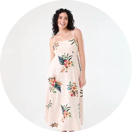 a woman wearing a summer maxi dress with tropical p