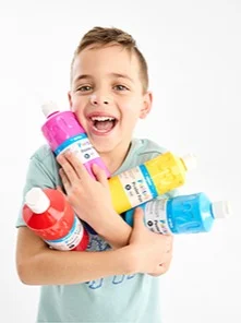 little boy carrying different colours of poster paint bot