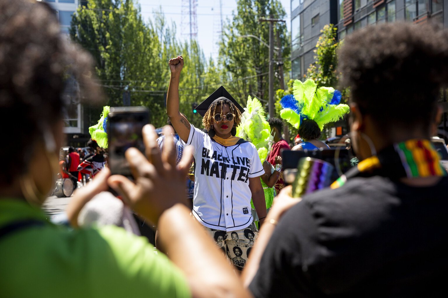 Tyriel Dominik, who graduated from the UW with a master's degree in social work, celebrates during the Juneteenth Freedom March and Celebration. (Sylvia Jarrus / The Seattle Times)