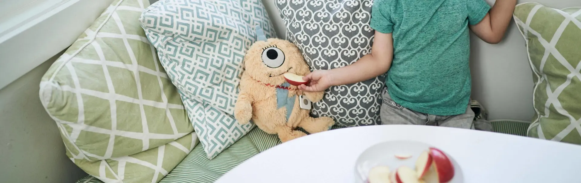 A child's plush toy with a Tile attached